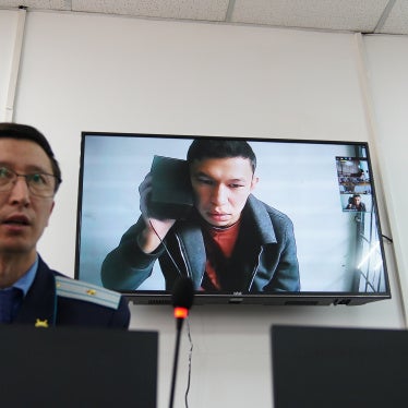 Qaznews24 founder Temirlan Yensebek appears onscreen at his trial in Almaty, Kazakhstan, April 9, 2025.