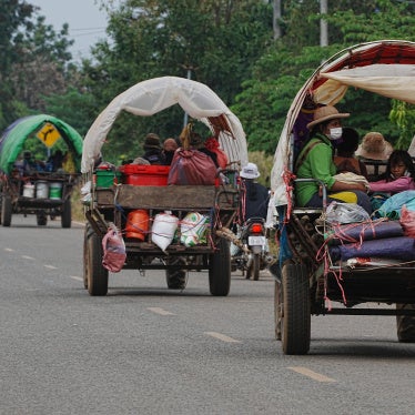 Cambodians flee their homes with their belongings on trucks