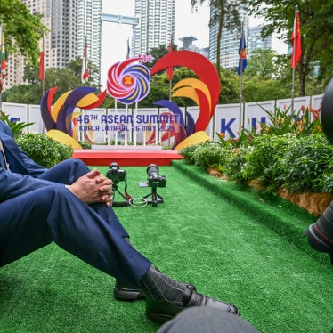 Malaysia's Prime Minister Anwar Ibrahim sitting in front of the 46th ASEAN Summit sign