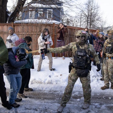 A US Border Patrol Tactical Unit agent sprays pepper spray into the face of a protestor near the scene where a woman was shot and killed by a federal agent, in Minneapolis, Minnesota, January 7, 2026.