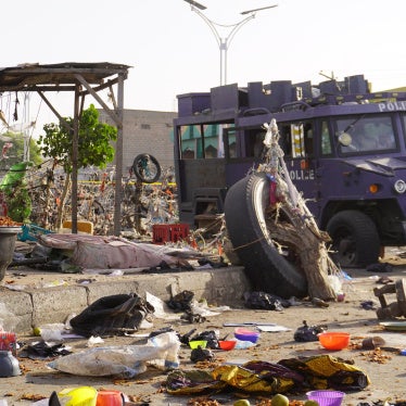 An armored police vehicle at a market in Maiduguri, Nigeria amid debris