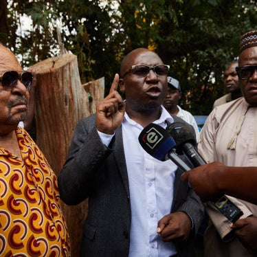 SAPES Trust director Ibbo Mandaza (L) listens to Jacob Ngarivhume (C) and Tendai Biti (R) speaking to the media at the Trust in Harare, Zimbabwe on October 28, 2025.