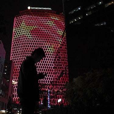 A person standing before an image of the Chinese national flag in Beijing, October 23, 2017. 