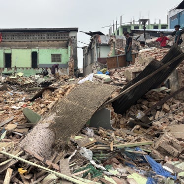 Following the March 28, 2025 earthquake in Myanmar, people clear debris from damaged buildings in Naypyidaw, April 7, 2025.