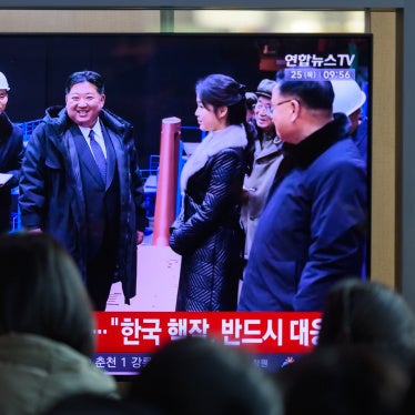 South Koreans in Seoul watch a news broadcast showing North Korean leader Kim Jong Un and his daughter visiting the undisclosed manufacturing site for a nuclear-powered submarine, December 24, 2025.