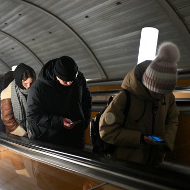 People use their smartphones while riding an escalator in the Moscow metro, Russia, on February 12, 2026.