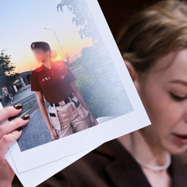 Kateryna Rashevska, a legal expert at the Regional Center for Human Rights (Kyiv, Ukraine), holds a picture she says depicts an abducted Ukrainian child, Washington DC, US, December 3, 2025.