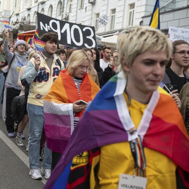 Participants at the 2025 Kyiv Pride Equality March display a placard supporting Draft Law 9103