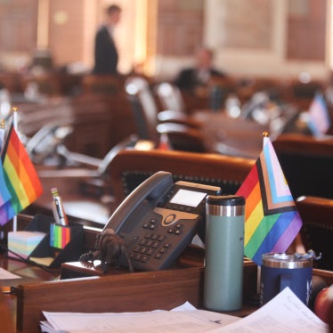 Transgender and LGBTQ rights flags sit on the desks of legislators in the Kansas House chamber in Topeka, February 19, 2026. 