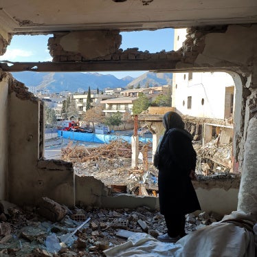 A woman looks out from her destroyed apartment in the Shahrak-e Gharb neighborhood of Tehran, Iran, March 21, 2026. 