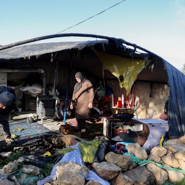 Residents inspect damaged belongings inside a tent burned by suspected Israeli settlers in the village of Susya in Masafer Yatta, south of Hebron, in the Israeli-occupied West Bank, February 25, 2026. 