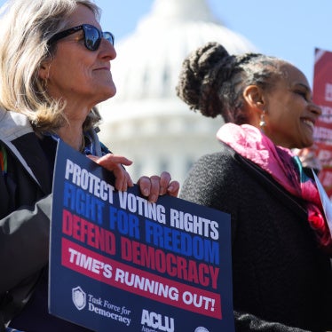 People hold signs at a rally and press conference against the SAVE America Act at the US Capitol in Washington, DC, on March 18, 2026.