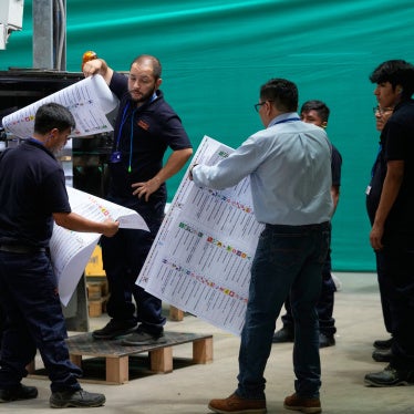 Electoral workers inspects a color test of newly printed ballots ahead of the presidential election, during a media presentation in Lima, Peru, Tuesday, March 10, 2026.