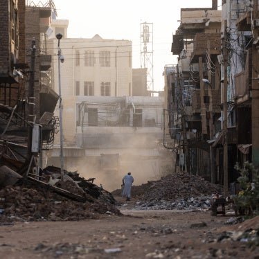 People pass through a destroyed section of Omdurman, Sudan on May 25, 2025. 