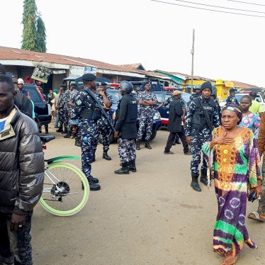 People gather as Nigerian policemen arrive at the scene the morning after gunmen killed multiple people in an overnight attack in Angwan Rukuba, Jos North, Plateau State, Nigeria, March 30, 2026. 