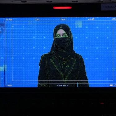 TV anchor Khatereh Ahmadi  wearing a face covering as she reads the news in Kabul, Afghanistan, May 22, 2022.