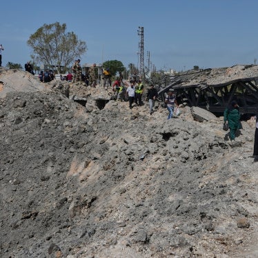 People cross on foot through a crater following an Israeli airstrike that destroyed the Qasmieh Bridge near the coastal city of Tyre, south Lebanon, April 16, 2026.