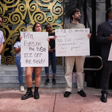 Protestors holding anti-ICE signs