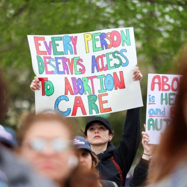 A supporter of Planned Parenthood holds a placard at a rally