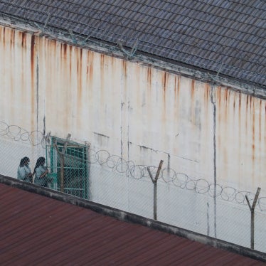 People walk inside an immigration detention center in Kuala Lumpur, Malaysia, February 23, 2023.