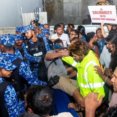 Police block protesters during a demonstration against the jailing of two journalists in the Maldives capital of Malé, on May 13, 2026. 