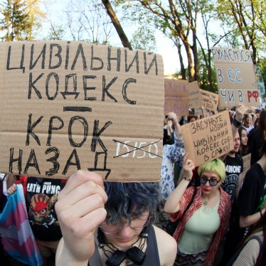 A placard reads "Civil Code Is Step Back" during a peaceful protest to urge MPs to refine the draft of the new Civil Code taking into account amendments proposed by human rights activists, in Mariinsky Park, Kyiv, Ukraine, May 5, 2026. 