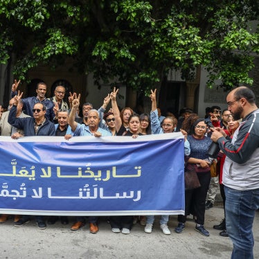 Demonstrators display a banner in Arabic reading, ''Our history will not be halted, and our message does not freeze,'' during a rally after Tunisian authorities suspended the Tunisian League for Human Rights, outside the court of First Instance in Tunis, May 6, 2026. 