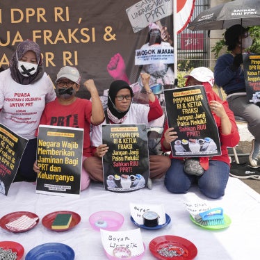 Activists demand the Indonesian parliament pass a bill to protect domestic workers outside the parliament building in Jakarta, August 14, 2023.