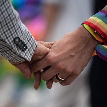 A same-sex couple hold hands during an event to raise awareness of gay rights in Hong Kong on May 25, 2019. 