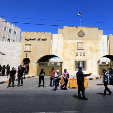 Security members stand guard outside the State Security Court in Amman, Jordan, July 12, 2021.