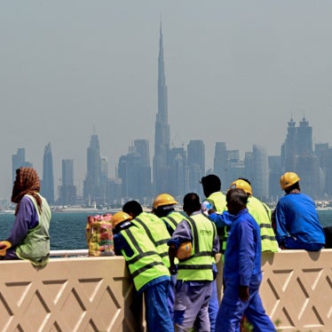 Workers sit on a wall against the backdrop of the city skyline, Dubai, UAE, March 11, 2026.