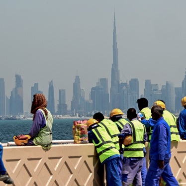 Workers sit on a wall against the backdrop of the city skyline, Dubai, UAE, March 11, 2026.