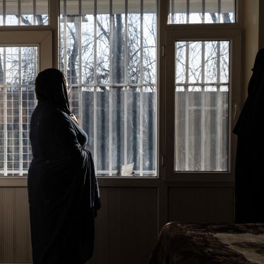 A woman looks out of a window