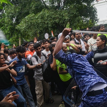 Police officers use batons to disperse protestors