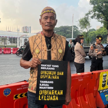 A man holds a placard at a demonstration