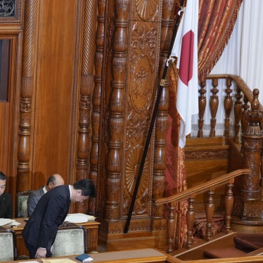 Japan's chief cabinet secretary, Minoru Kihara, bows to members of the House of Councilors after lawmakers passed a law prohibiting desecration of the national flag, Tokyo, July 17, 2026.