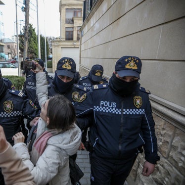 Police removing journalists from Toplum TV on March 6, 2024 in Baku, Azerbaijan.