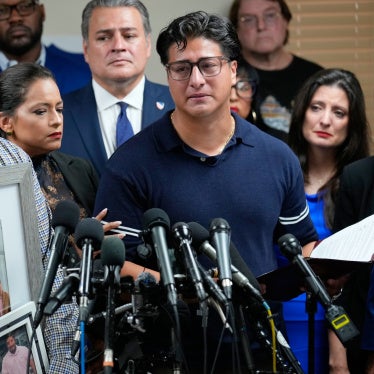 Ronaldo Salgado (right), son of Lorenzo Salgado Araujo, speaks as his brother, Lorenzo Jr. holds family photographs during a news conference in Houston, Texas, July 8, 2026.