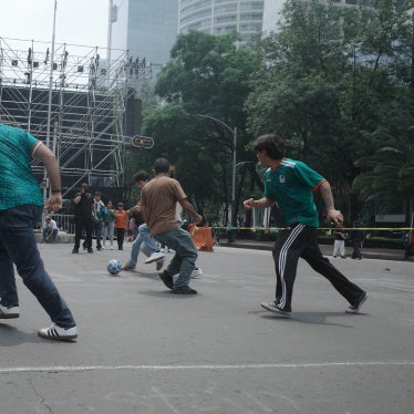 Passersby take part in a pickup football game organized by civilian search collectives on Mexico City's Paseo de la Reforma during the World Cup, July 2026. 