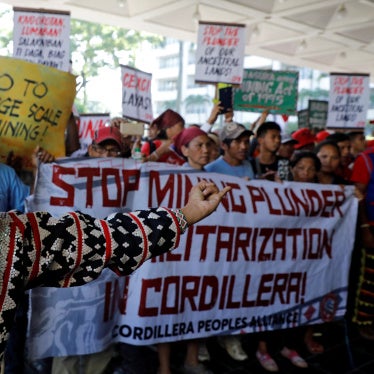 An anti-mining protester speaks during a rally outside the annual Philippines mining conference in Pasay, Metro Manila, September 6, 2017.