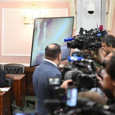 Lawyer Vitaly Iskakov (left), attorney Gadzhi Aliyev (center) and Chairman of the Yabloko political party, Nikolai Rybakov, attend a hearing on a lawsuit filed by the Rodina (Motherland) party seeking to bar the Yabloko party from the State Duma election, at the Russian Supreme Court in Moscow, Russia, August 10, 2026.