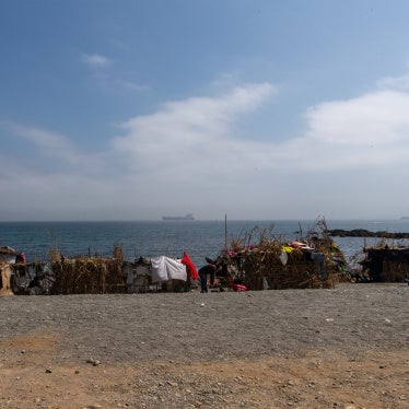 Two of the migrants and asylum seekers who swan to Ceuta in July 2026, walk on the Trampolín beach, August 2026.