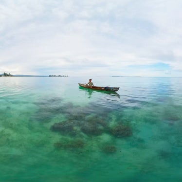 A girl in her fishing boat off the coast of Malaita Province, Solomon Islands. 