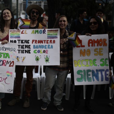 people hold placards at a pride march