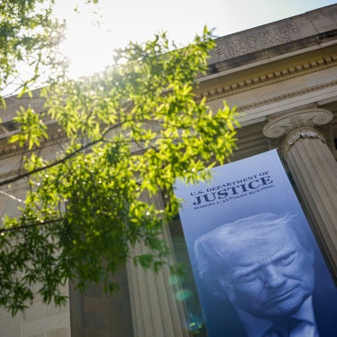 An image of US President Donald Trump hangs from the Department of Justice Building in Washington, DC, May 18, 2026.