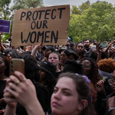 Participants hold signs during a gender-based violence protest at the forecourt of the botanical gardens in Johannesburg, South Africa, November 21, 2025.