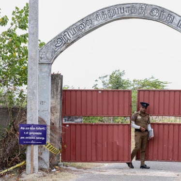 A police officer stands guard in front of the Chemmani mass grave site in Jaffna, Sri Lanka, July 26, 2025.