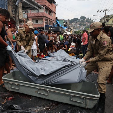 Firemen lift bodies recovered from the nearby forest in Saint Luke Square in Complexo da Penha