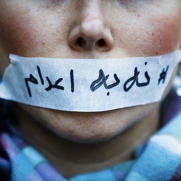 A person's mouth covered with tape bearing a message “no to executions” in Iran, in Paris in France, January 31, 2026.