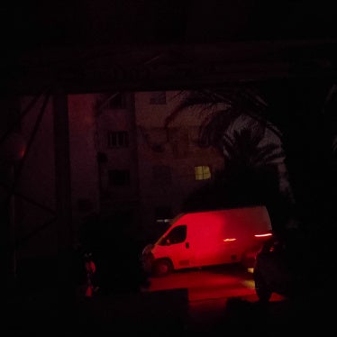 Cars pass through a darkened street during a nighttime power outage in Ariana, Tunisia, July 14, 2026.
